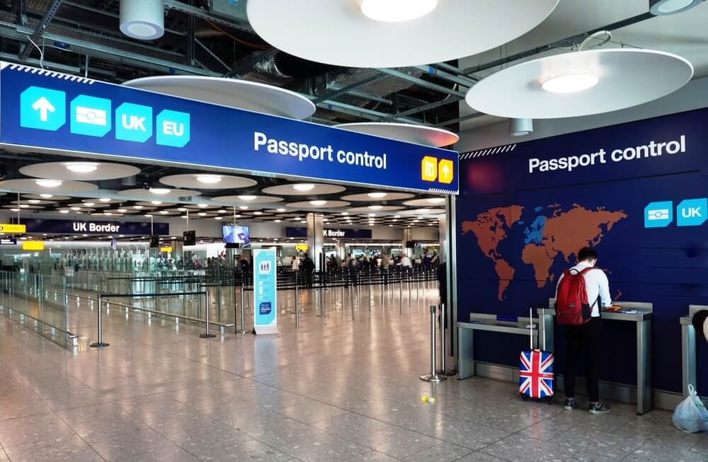 Man standing at the U.K. border waiting on passport control in london heathrow 