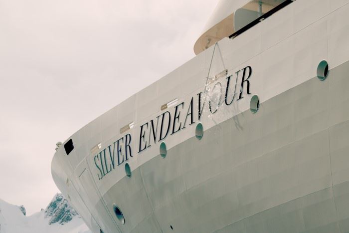 An ice-sculpted Champagne magnum breaks against the hull of the Silver Endeavour