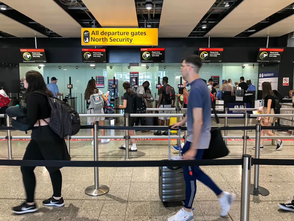 Passengers lining up at security in London heathrow terminal 3 