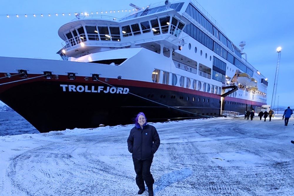 dori saltzman in norway in front of hurtigruten's ms trollfjord