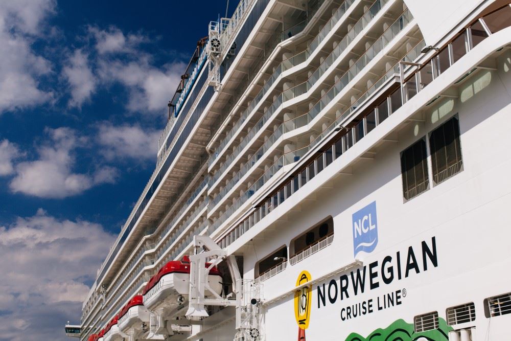 upclose look at an norwegian cruise line ship on which e-musters have returned