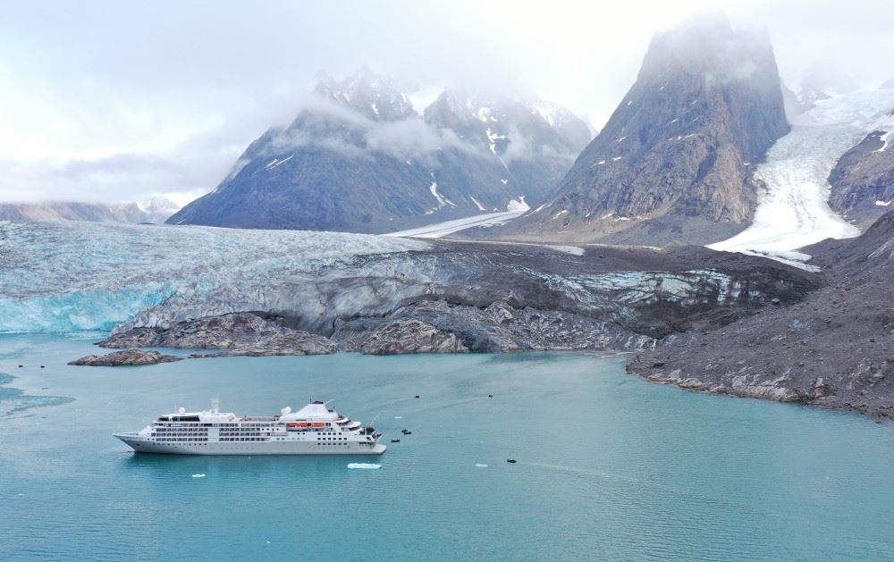 silversea cruise ship surrounded by glaciers in the arctic