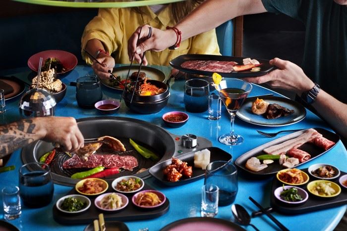 meal spread out across the table at Gunbae on virgin voyages cruise ship