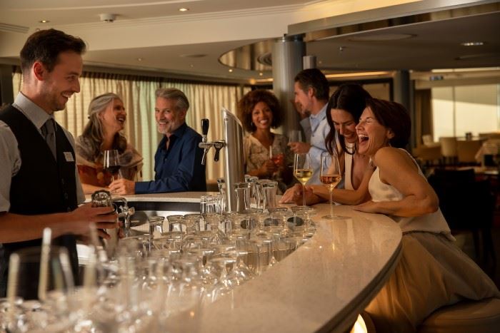 guests on avalon waterways enjoying free drinks at happy hour