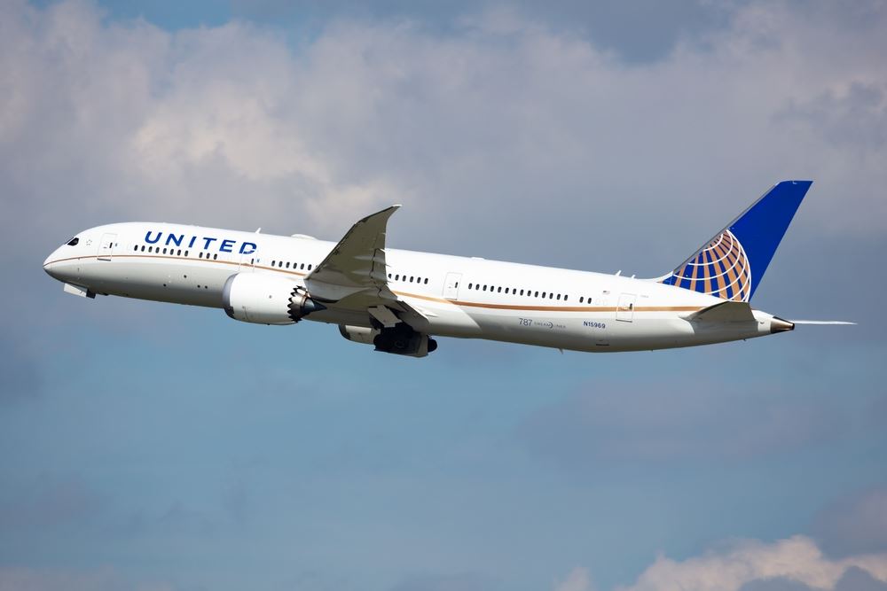 United Airlines plane flying in sky 