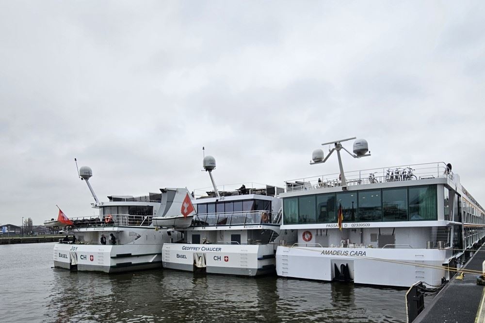 three river cruise ships side by side in amsterdam