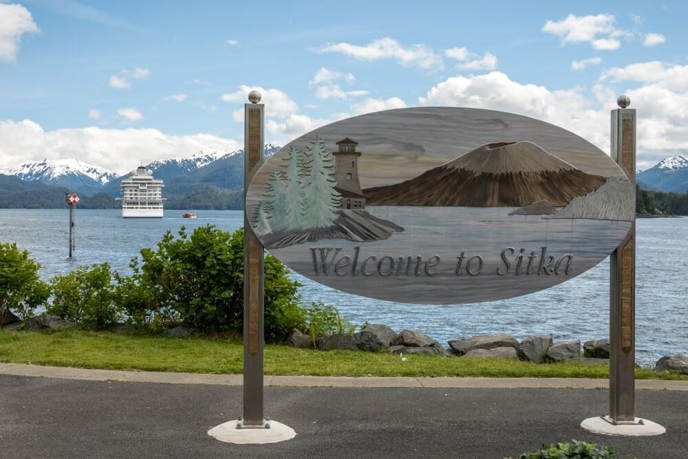 welcome to sitka sign with cruise ship in the background alaska