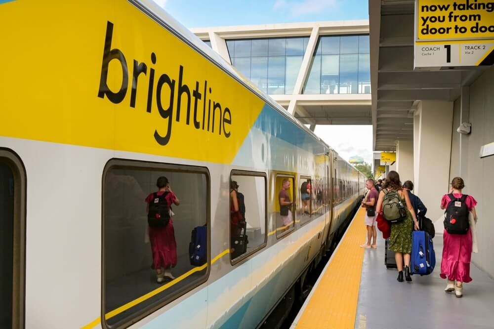 Passengers walking next to a Brightline Train in Florida 