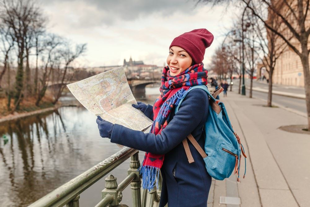 asian woman exploring prague during the off-season with escapes by globus