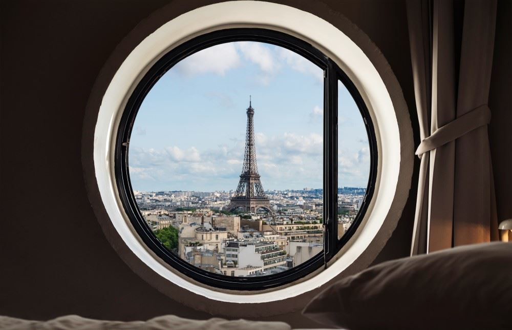 eiffel tower as seen through a hotel window