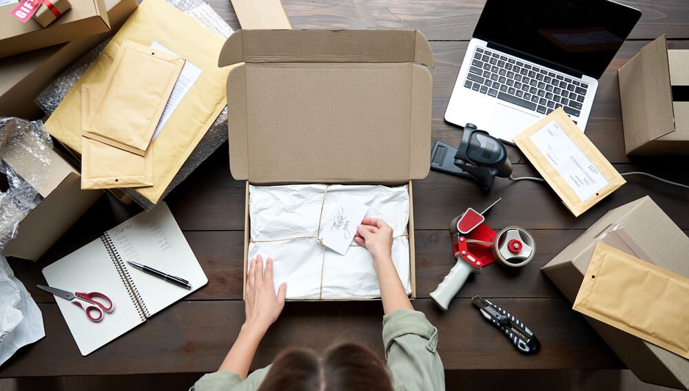 travel agent packing a gift box for their client 